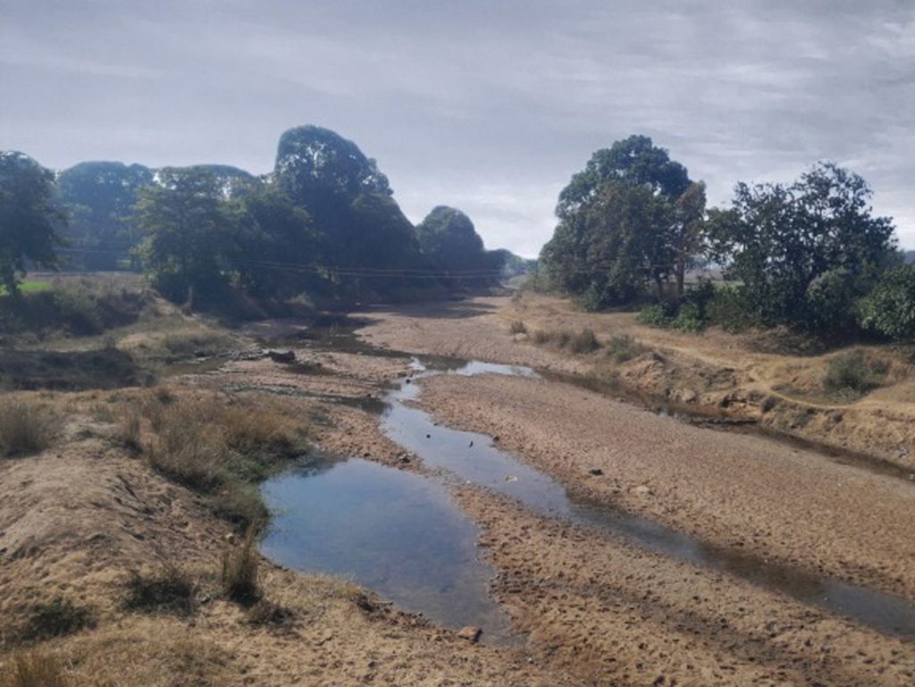 A dry river with sand and a little bit of water in Kairo, Jharkhand, India.